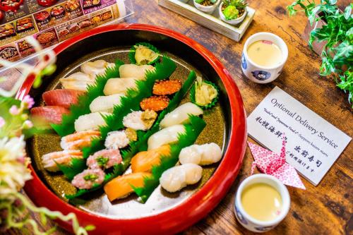 a plate of food with sushi and shrimp on a table at A-JA in Niki