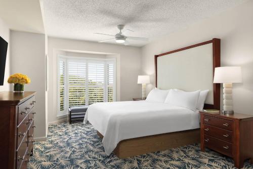a bedroom with a large white bed and a window at Marriott's Heritage Club in Hilton Head Island