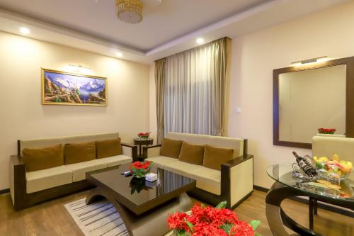 a living room with a couch and a table at Dreamland Gold Resort & Hotel in Bhairāhawā