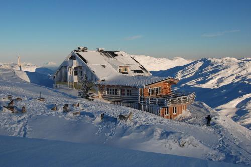 a house on top of a snow covered mountain at Lodge am Krippenstein in Obertraun