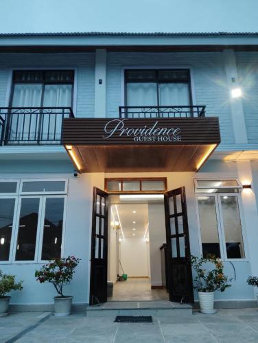 a building with a sign for a guest house at Providence Guesthouse in Churāchāndpur