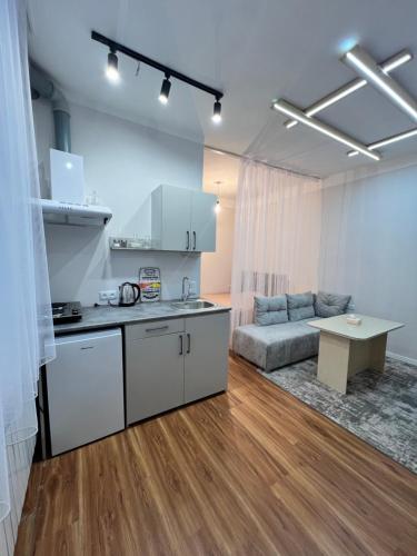 a kitchen and a living room with a couch at "STAIRS"guest house in Yerevan