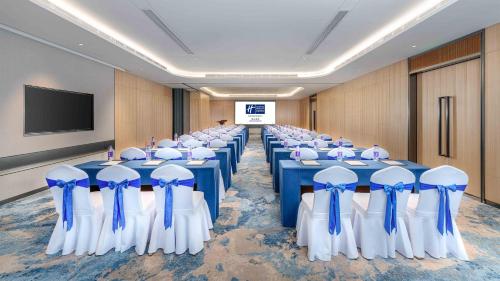 a conference room with blue and white tables and chairs at Holiday Inn Express Foshan Shunde Lecong by IHG in Shunde