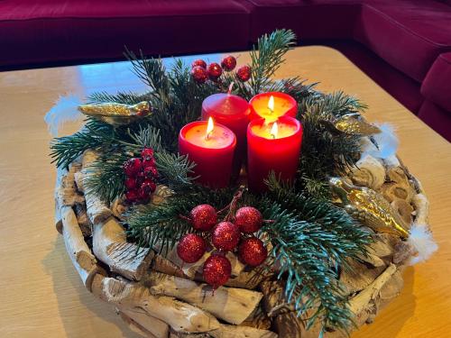 a wreath with three candles on a table at Villa Kitzbühel in Kirchberg in Tirol