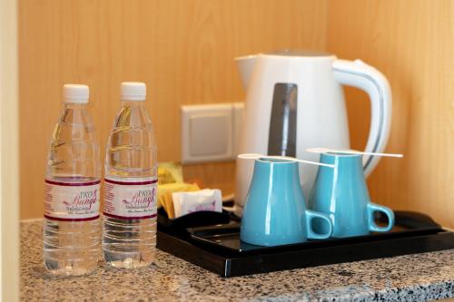 two bottles of water and a blender on a counter at Paya Bunga Hotel Terengganu in Kuala Terengganu