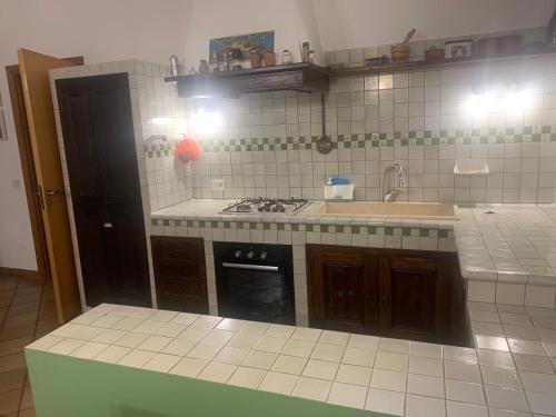 a kitchen with a sink and a stove at La Finestra su Mothia in Marsala