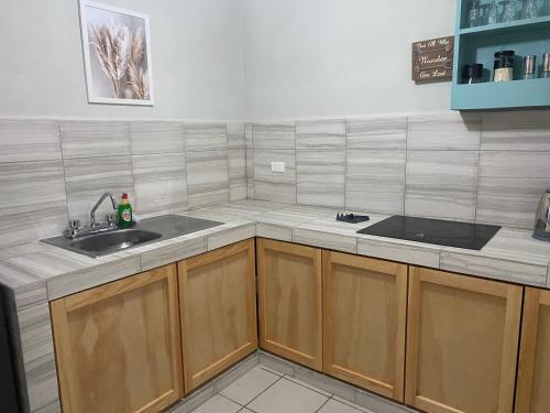 a kitchen with wooden cabinets and a sink at Budgie's 2 Studio in Cozumel