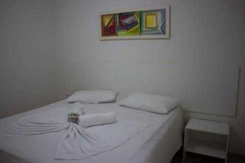 
A bed or beds in a room at Pousada Nossa Casa
