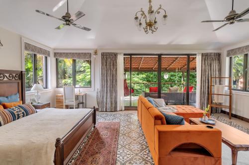 a living room with a large bed and a couch at Villa Stairway to Heaven by tisyastays in Candolim