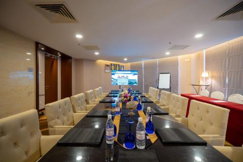 a long table in a room with chairs and water bottles at Paya Bunga Hotel Terengganu in Kuala Terengganu