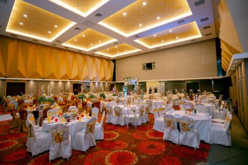 a large banquet hall with white tables and chairs at Paya Bunga Hotel Terengganu in Kuala Terengganu