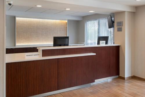 a lobby with a reception desk in a hospital at Fairfield by Marriott Rochester Henrietta/University Area in Henrietta