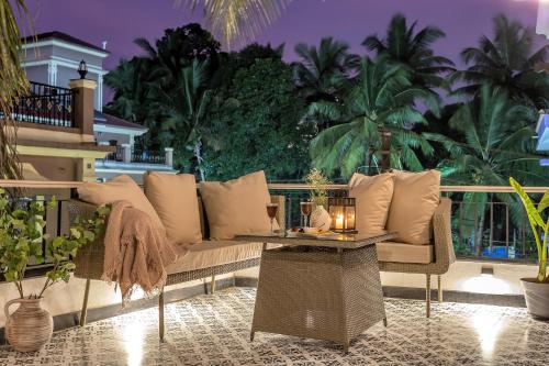 a living room with a couch and a table at Villa Stairway to Heaven by tisyastays in Candolim