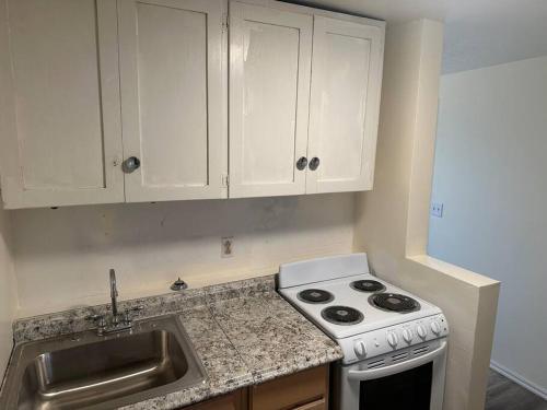 a kitchen with a stove and a sink at Cozy 1-Bedroom Apartment in Roy in Roy