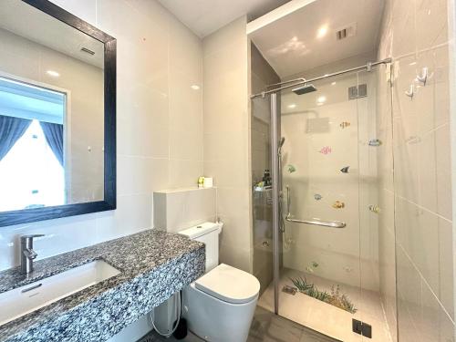 a bathroom with a shower and a sink and a toilet at Azure Residences by Sleepy Bear Paradigm Mall in Petaling Jaya