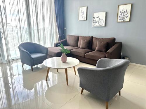 a living room with a couch and two chairs and a table at Azure Residences by Sleepy Bear Paradigm Mall in Petaling Jaya