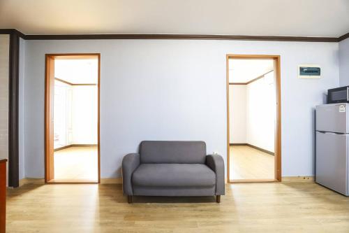 a living room with a chair and two mirrors at Boryeong BonGaya Hotel in Boryeong