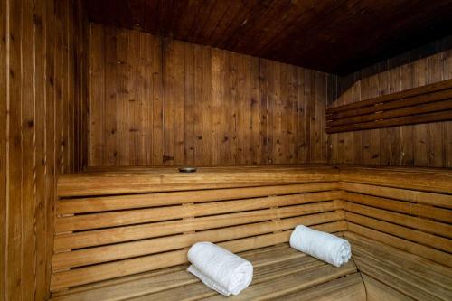 a wooden sauna with two white pillows in it at Clarion Aparthotel Toulouse Blagnac Airport in Blagnac