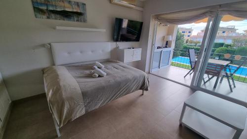 a bedroom with a bed with a teddy bear on it at VIDABRAVA, Sagaro garden loft in S'Agaro