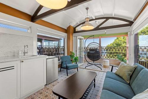 a kitchen and living room with a couch and a table at Elegant 6-Bed Home with Harbour Views in Sydney