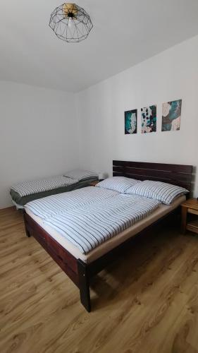a bed sitting in a room with at Appartamento - Cave del Predil in Cave del Predil
