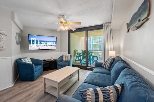 a living room with a blue couch and a table at Harbour Place 310 in Gulf Shores