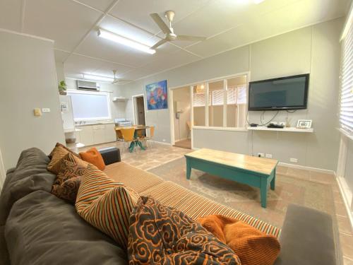 a living room with a couch and a flat screen tv at 5 Learmonth Street in Exmouth