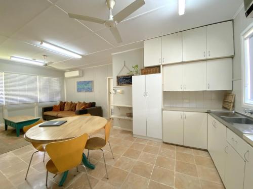 a kitchen and living room with a table and a couch at 5 Learmonth Street in Exmouth