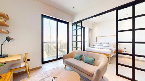 a living room with a couch and a bed at The Community Jumeirah Village in Dubai