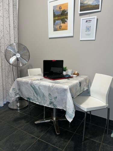 a table with a laptop on it with two chairs at Midway En Route in Harrismith