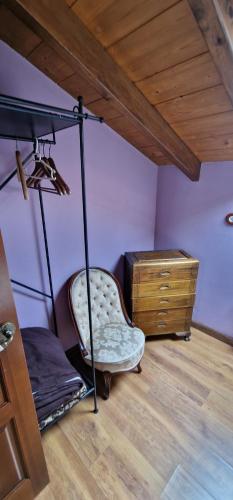 a room with a bed and a chair and a dresser at Redes - El Descanso - AR-484-AS in Caso