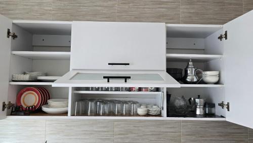 a kitchen with a white hood and some dishes at Le doux refuge - à 7 mn de la plage à pieds in Temara