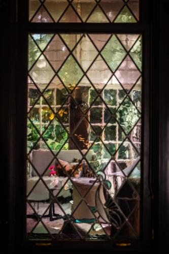 a view through a stained glass window of a room at Kasteel Kerckebosch in Zeist