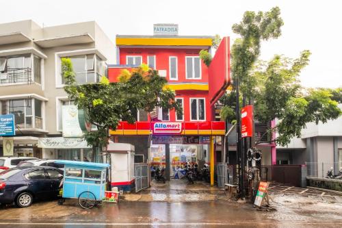 a red and yellow building on a city street at Hotel O Riau Near Gedung Sate Formerly Patradisa in Bandung