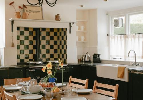 North CerneyにあるTrinity Farmhouse - Stunning House & Gardens!のキッチン(テーブル、椅子、シンク付)