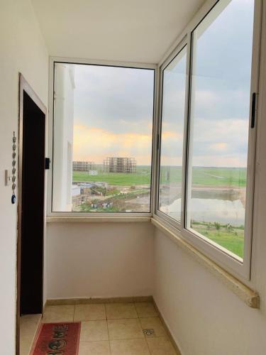 a room with two large windows with a view at 2 Bedrooms At Caesar Resort & Spa Iskele Claudius 9 in Iskele