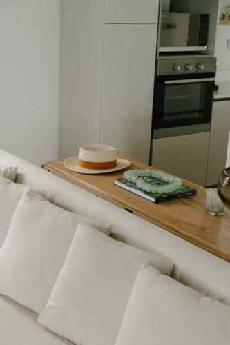 a kitchen with a table with a hat on it at Tamarin Sunset Beach II in Tamarin