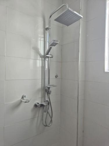 a shower in a bathroom with a shower head at Daffi giraffi House in Malindi
