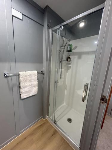 a shower with a glass door in a bathroom at On the water boat House in Whangarei