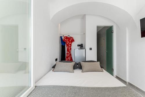 a bedroom with a bed in a white room at Naxian Queen Luxury Villas & Suites in Agia Anna Naxos