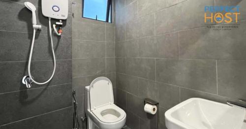 a bathroom with a shower and a toilet and a sink at Neu Suites @ 3rdNvenue by Perfect Host in Kuala Lumpur