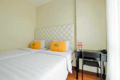 Ένα ή περισσότερα κρεβάτια σε δωμάτιο στο Panen Hotel