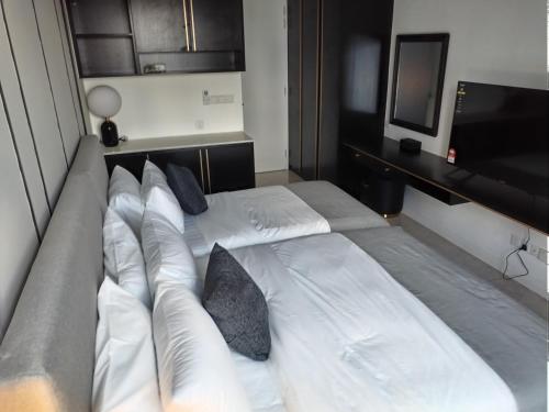 a bedroom with two beds and a flat screen tv at Bukit Bintang Axon Residences 3R2B 3Queens Beds in Kuala Lumpur