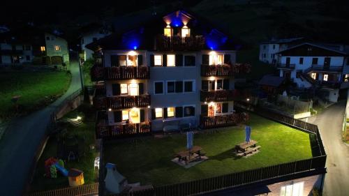 a large white building with blue lights on it at Residence Casa Federica in Valfurva