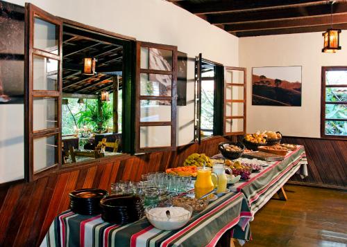 a long table with food on it in a room at Pousada da Gruta in Visconde De Maua