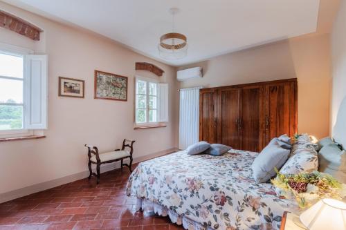 a bedroom with a large bed with blue pillows at Villa Papari in Montecarlo