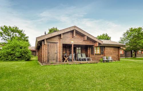 a log cabin with a porch on a lawn at Ferienhaus Donau 89 in Hayingen