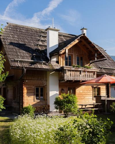 a wooden house with a porch and a balcony at st martin chalets in Sankt Michael im Lungau