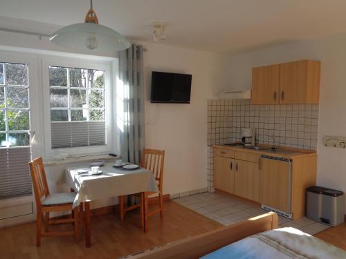 a kitchen and dining room with a table and chairs at Ferienhof Lüke in Wesselburener Deichhausen
