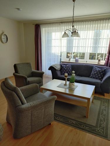 a living room with a couch and a coffee table at Ferienhof Lüke in Wesselburener Deichhausen